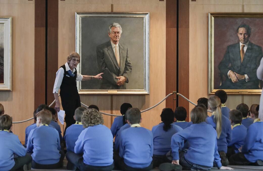 Parliament House tour guide Gina Hall speaks to students from Lake Joondalup Baptist College in Western Australia, in front of former prime minister Bob Hawke's portrait. Picture: Alex Ellinghausen