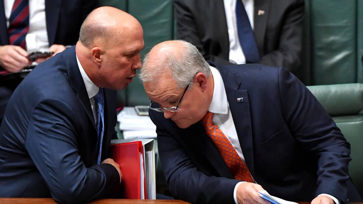 Home Affairs Minister Peter Dutton (left) with Prime Minister Scott Morrison in Parliament on Thursday. Picture: AAP Image/Sam Mooy