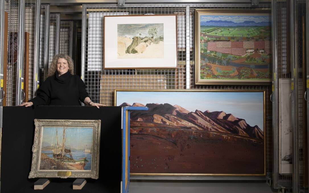 Director of the Parliament House art collection Justine van Mourik with a painting by Winston Churchill of the French Riviera, and two of the paintings chosen by Nationals MP Mark Coulton for his office: 'Near dead horse gully', Tibooburra 1983 by Max Miller, top left, and 'Wilpena evening' 1986 by Jeffrey Makin, bottom right. Picture: Sitthixay Ditthavong