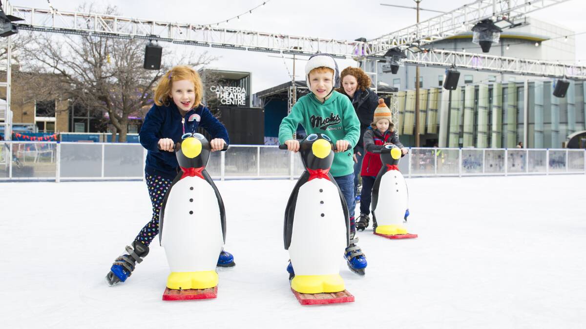 Marcella Incoll, 7, and Tom Incoll, 5, race each other at the open air ice rink in Civic Square on Friday. Picture: Dion Georgopoulos