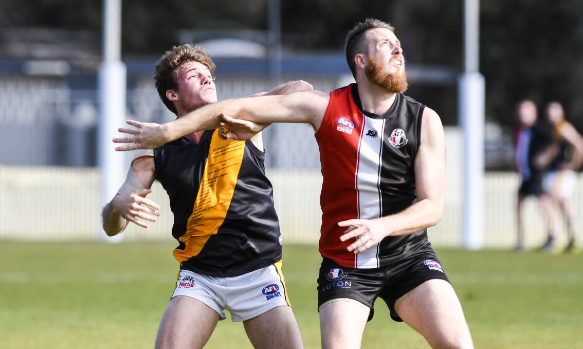 Queanbeyan's Jonathon Bowyer and Ainslie's Jayden Armstong looking to catch the ball. Picture: Dion Georgopoulos