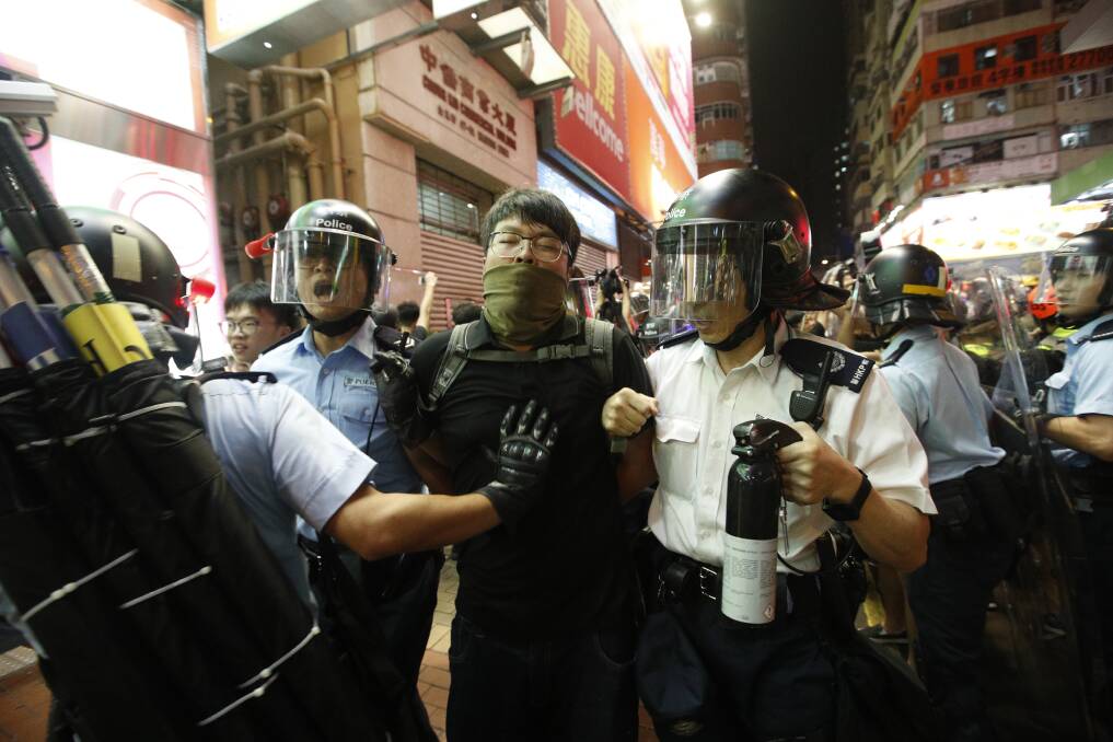 Police officers arrest a protester in Hong Kong on July 7, 2019. Picture: AP