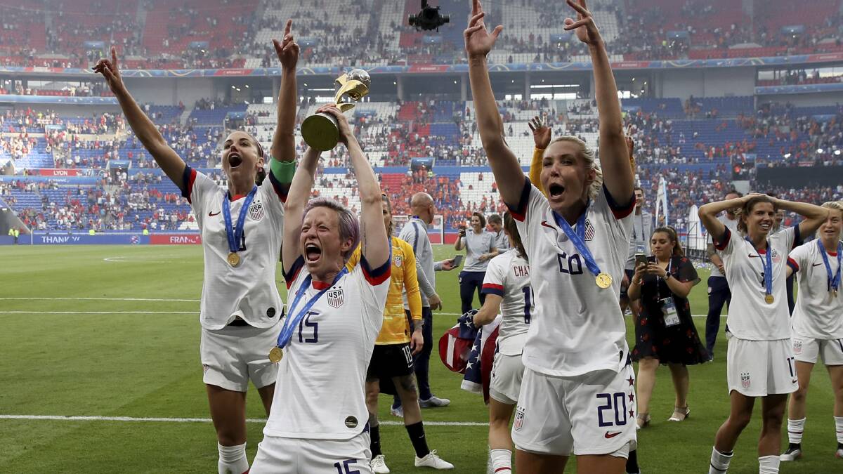 United States' Megan Rapinoe raises the World Cup trophy in triumph. Picture: AP