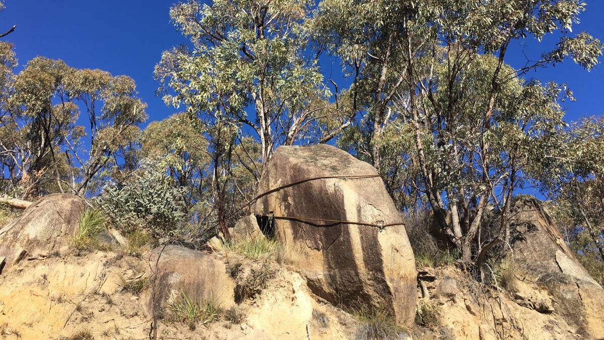 Steel cables prevent this boulder from falling onto the current Apollo Road to Honeysuckle Creek. Picture: Tim the Yowie Man