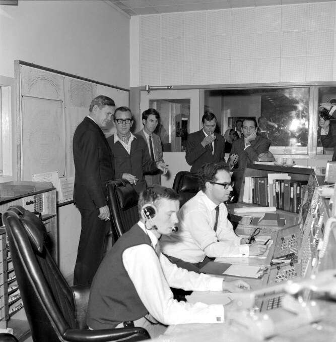 Prime Minister John Gorton visits the Honeysuckle Creek Tracking Station on the morning of July 21, 1969. Seated is John Saxon and Ian Grant. Next to the Prime Minister is station director Tom Reid. Picture Hamish Lindsay and Colin Mackellar
