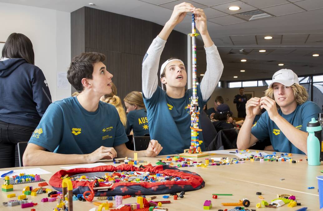 Swimmers Tom Neill (QLD), Noah Millard (VIC), and Kalani Ireland (WA) participate in a Lego building exercise during an AIS camp in the lead-up to the world junior swimming championships in Budapest in August. Picture: Sitthixay Ditthavong