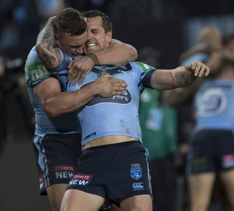 Jack Wighton and Mitchell Pearce celebrate after winning the series. Picture: AAP