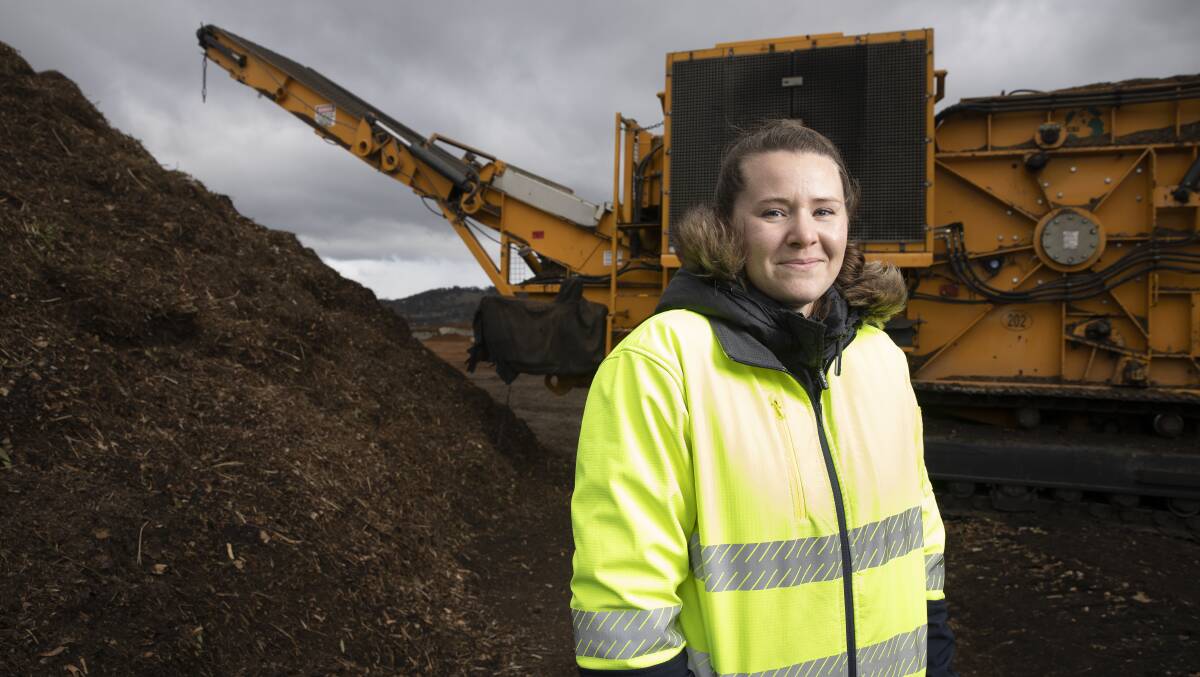 Kathryn Sullivan of EnviroCom, which organises the collection of green garden waste for the ACT government. The machine grinds it up at the Corkhill Brothers site on Mugga Lane. Picture: Sitthixay Ditthavong
