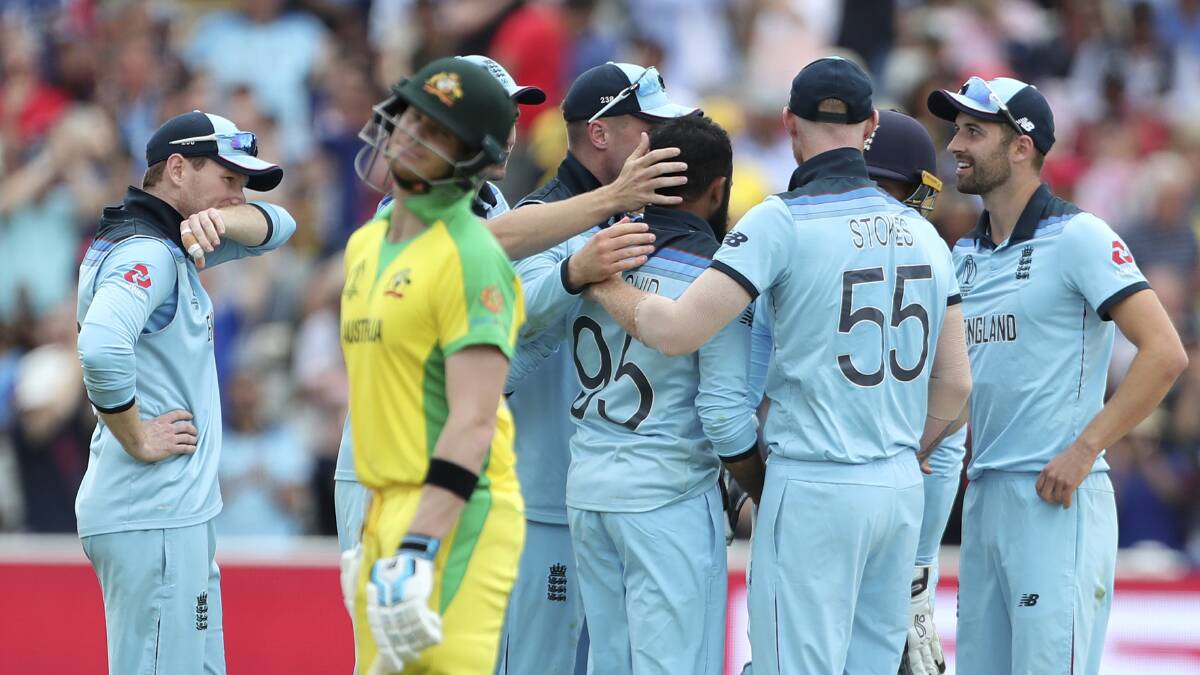 England's Adil Rashid celebrates with teammates after dismissing Steve Smith. Picture: AP