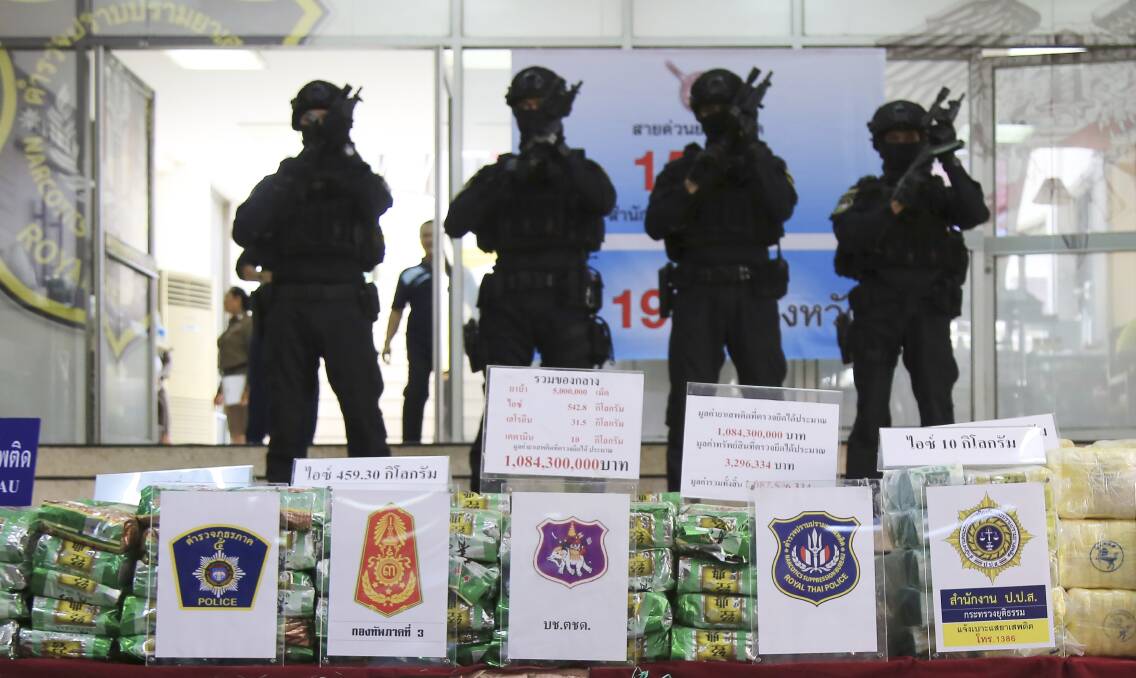 Thai policemen stand in front of packages of seized methamphetamines in Bangkok. Picture: AP