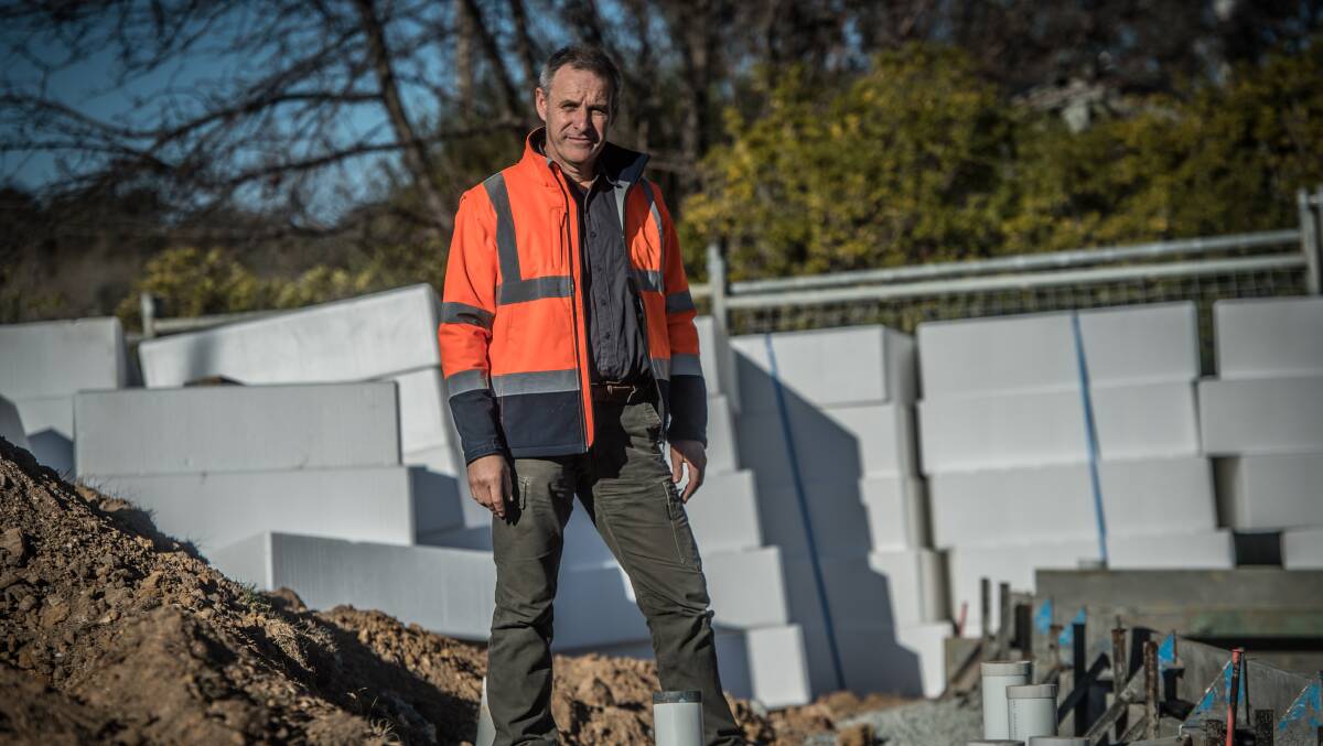 Building certifier Livi Krevatin on a site in Aranda. He says certifiers are in dire stress over spiraling insurance costs and new liabilities imposed by the government. Picture: Karleen Minney