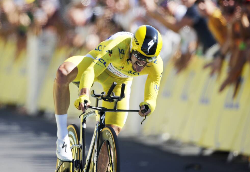 France's Julian Alaphilippe wearing the overall leader's yellow jersey crosses the finish line to win the 13th stage of the Tour de France. Picture: AP