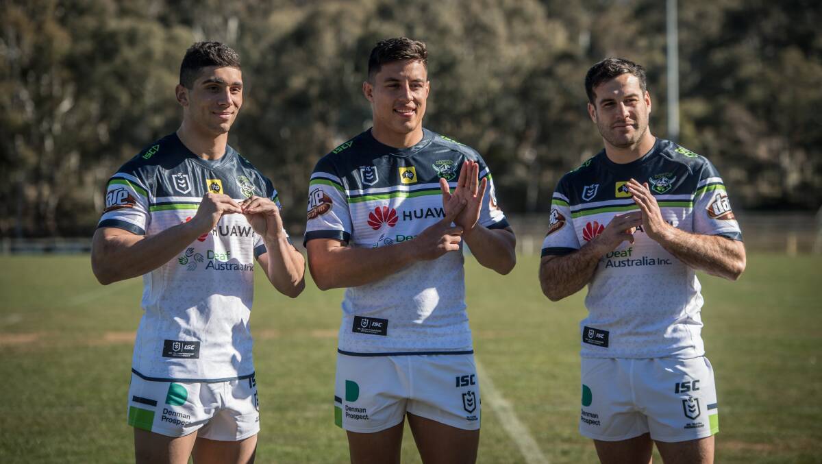 Bailey Simonsson, Joe Tapine and Michael Oldfield model the special jersey to help raise awareness and funds for Deaf Australia. The jumper has the Auslan alphabet printed on it. Picture: Karleen Minney