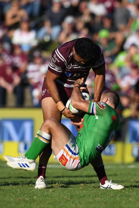 Toafofoa Sipley of the Sea Eagles fights for the ball with Josh Hodgson of the Raiders. Picture: AAP