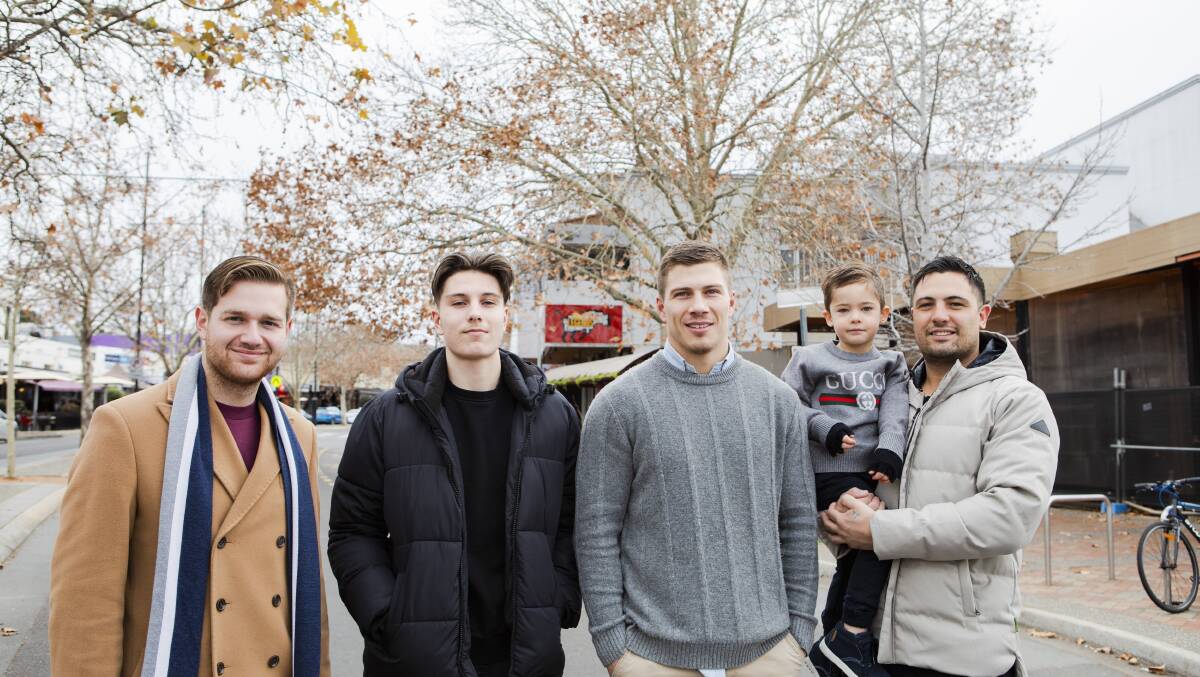 From left, Inner-South Business Councils' John-Paul Romano, Caphs Cafe's Luka Notaras, Public's Scott Barrie, and Trecento owner Josh Kosteski and Adrijan, 4, near the tree Franklin Street tree on Monday. Picture: Jamila Toderas