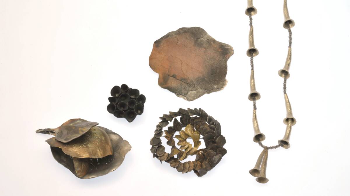 From left, Bloodwood leaves brooch, Small black brooch,WA rock brooch, Celerytop pine small leaves,Gum caps necklace in Marian Hosking's Gardens . Picture: Supplied
