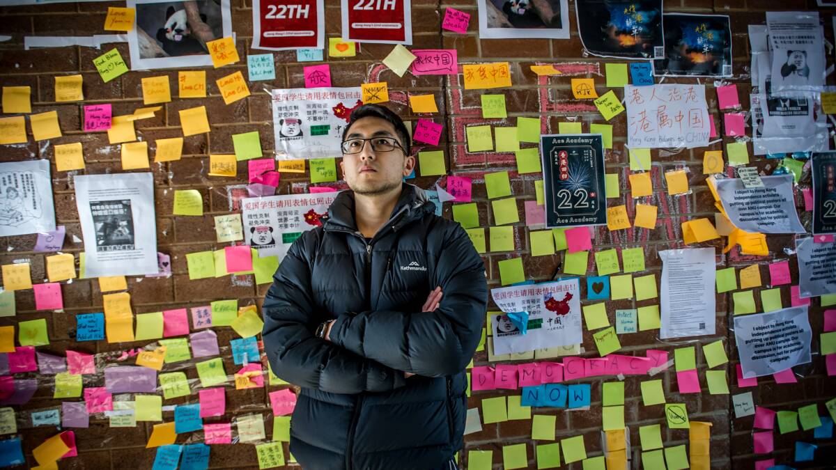 Pro-democracy activist Yutong Wu in front of a student protest wall at the ANU. Picture: Karleen Minney.