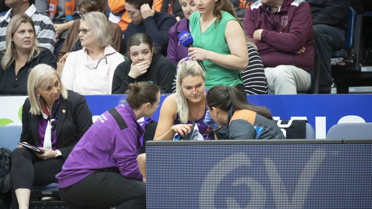 Firebirds' Gretel Tippett is sidelined by a bloody injury in the first quarter. Picture: Sitthixay Ditthavong