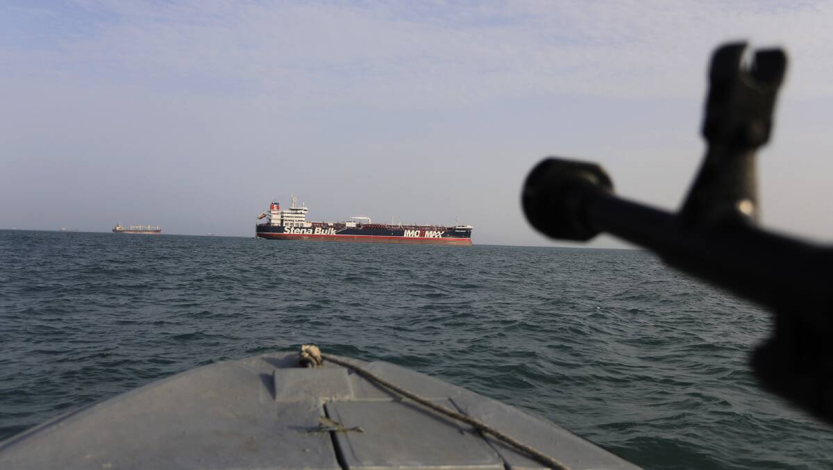 A speedboat of Iran's Revolutionary Guard trains a weapon toward the British-flagged oil tanker Stena Impero.