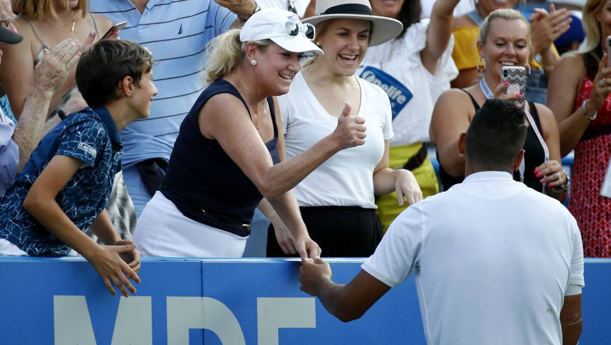 A spectator in the stands gives Nick Kyrgios the thumbs-up after he asked her where to serve on match point. Picture: AP Photo