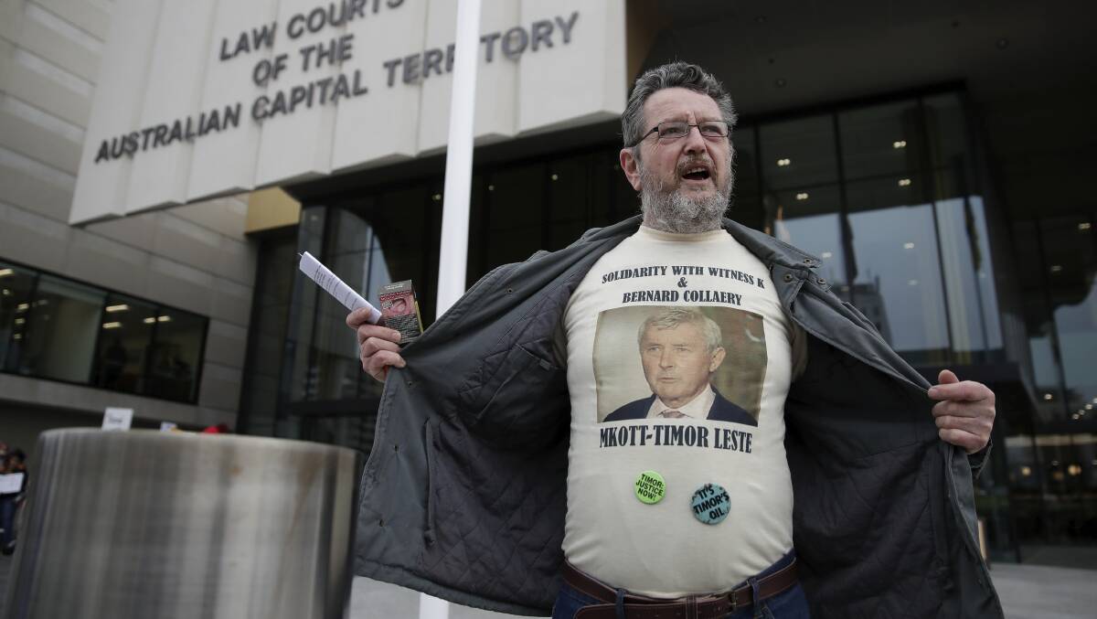 A protester supporting Canberra lawyer Bernard Collaery at the ACT Law Courts in August. Picture: Alex Ellinghausen