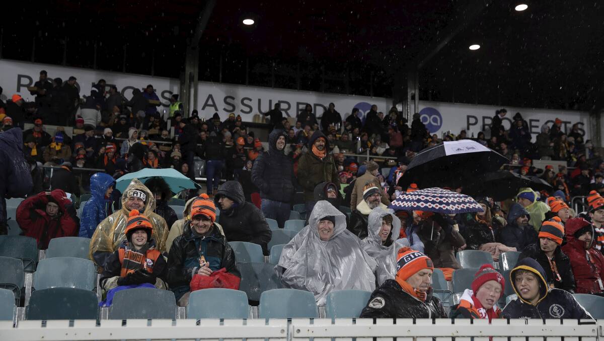 The crowd began to thin as snow fell but plenty stayed firm. Picture: Alex Ellinghausen