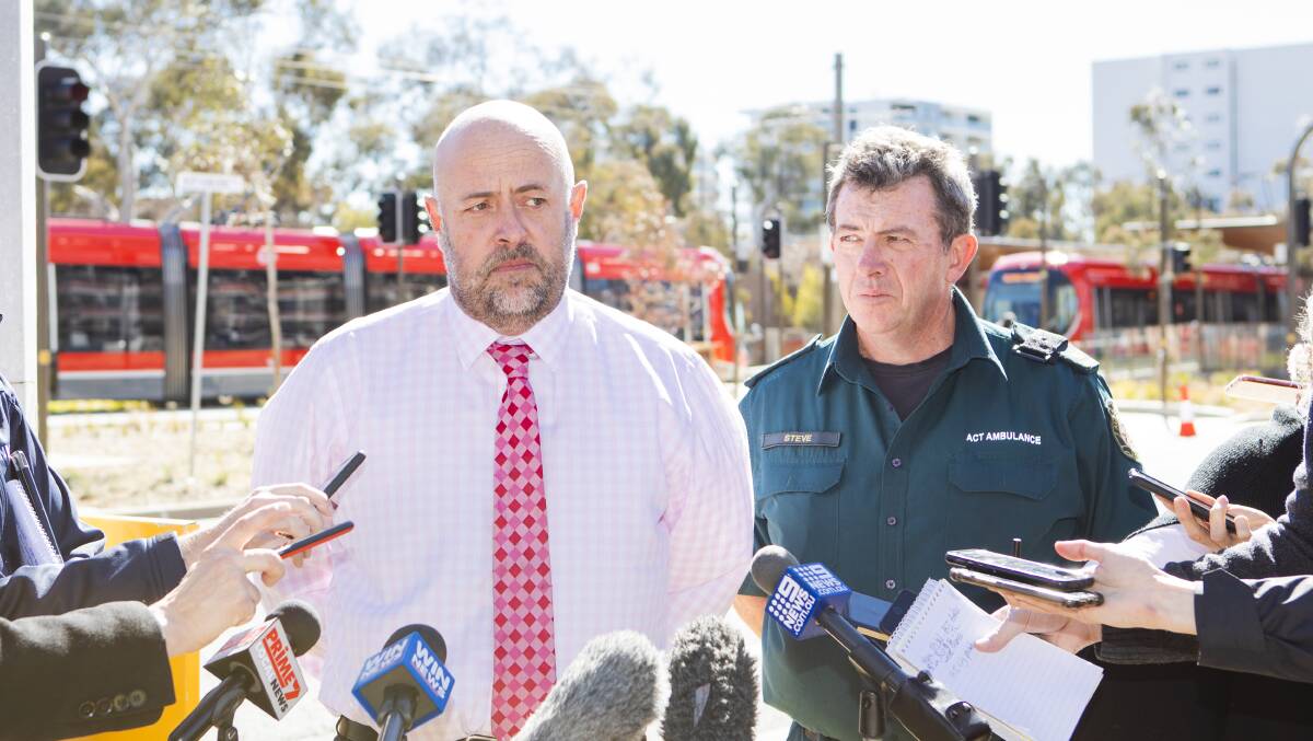 Ian McGlinn of Transport Canberra, and Steve Mitchell of ACT Ambulance service, addressing the media following Monday's crash between a pedestrian and a tram. Picture: Jamila Toderas