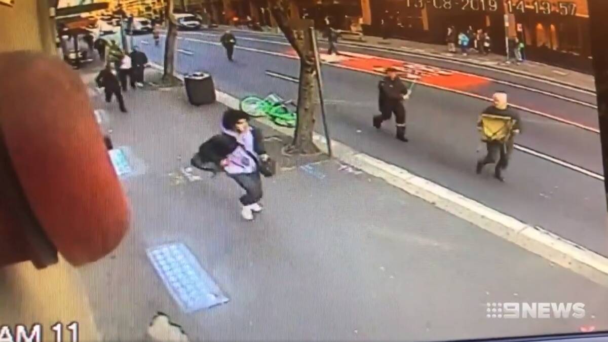 A still from CCTV footage of Mert Ney, 21, wielding a butcher's knife as he ran down a Sydney street before being overpowered by members of the public. Picture: Nine News