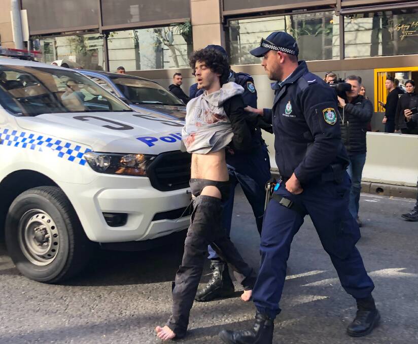 Mert Ney is arrested after being detained by members of public. Picture: AAP