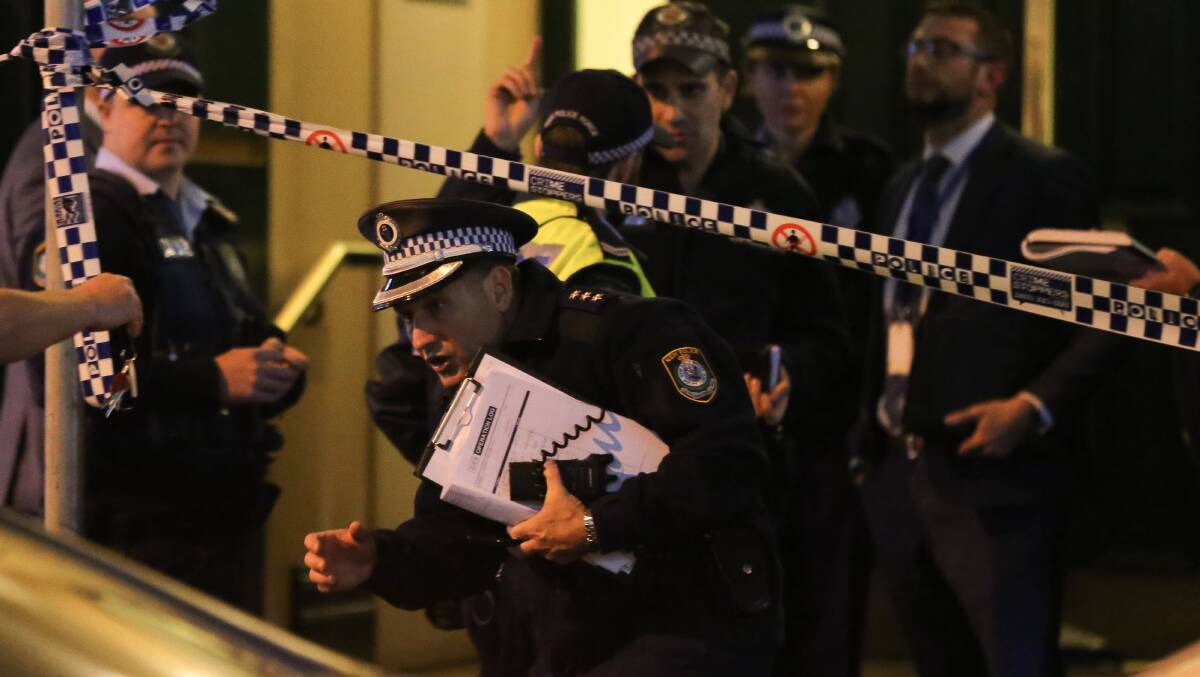 Police are seen outside of an apartment building on Clarence street during a police operation on Tuesday night. Picture: AAP