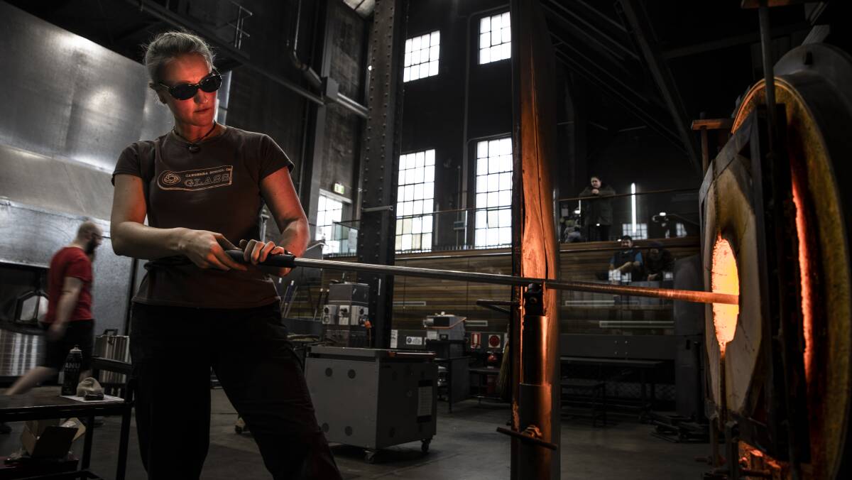 Glass blower Nadina Geary, working on a creation at Canberra Glassworks. Picture: Sitthixay Ditthavong