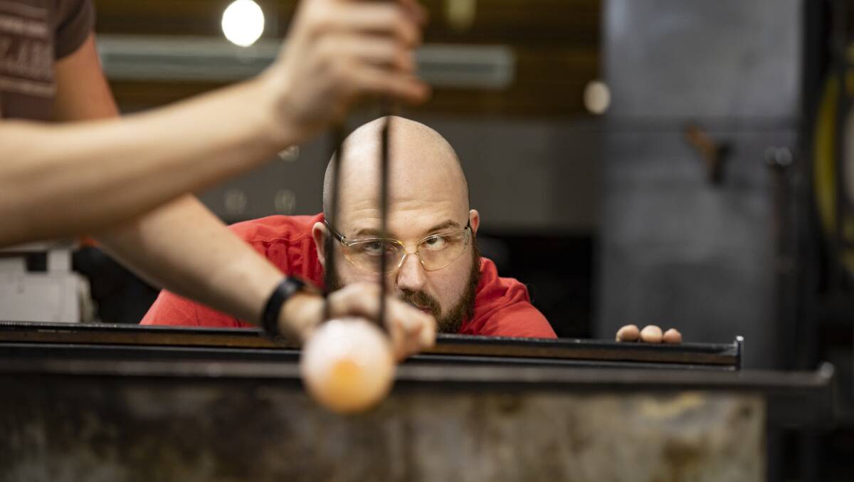Nick Doran-Adams, one of the skilled glassblowers at Canberra Glassworks. Picture: Sitthixay Ditthavong