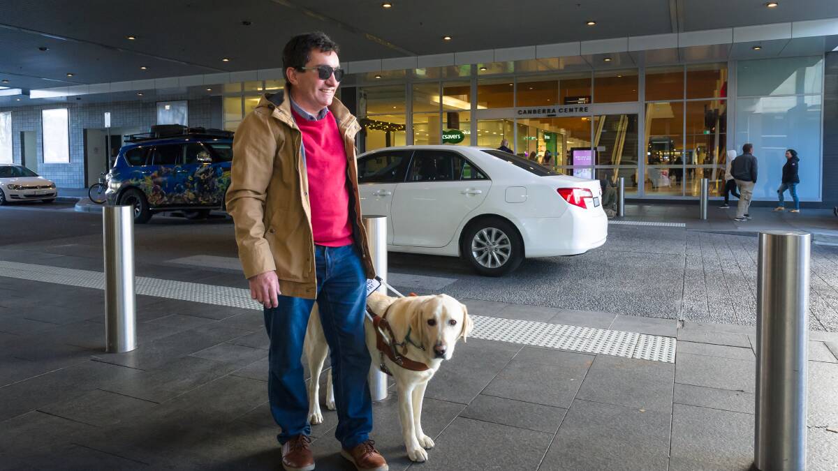 Dave Brown, pictured with his guide dog Corrie, has had a close brush with a near-silent hybrid car and is glad to hear regulations will force manufacturers to introduce an audible alert system. Picture: Elesa Kurtz
