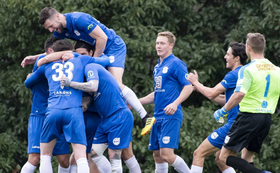 Canberra Olympic players celebrate Stephen Domenici's opening goal in their 4-0 win over Tigers FC. Picture: Sitthixay Ditthavong