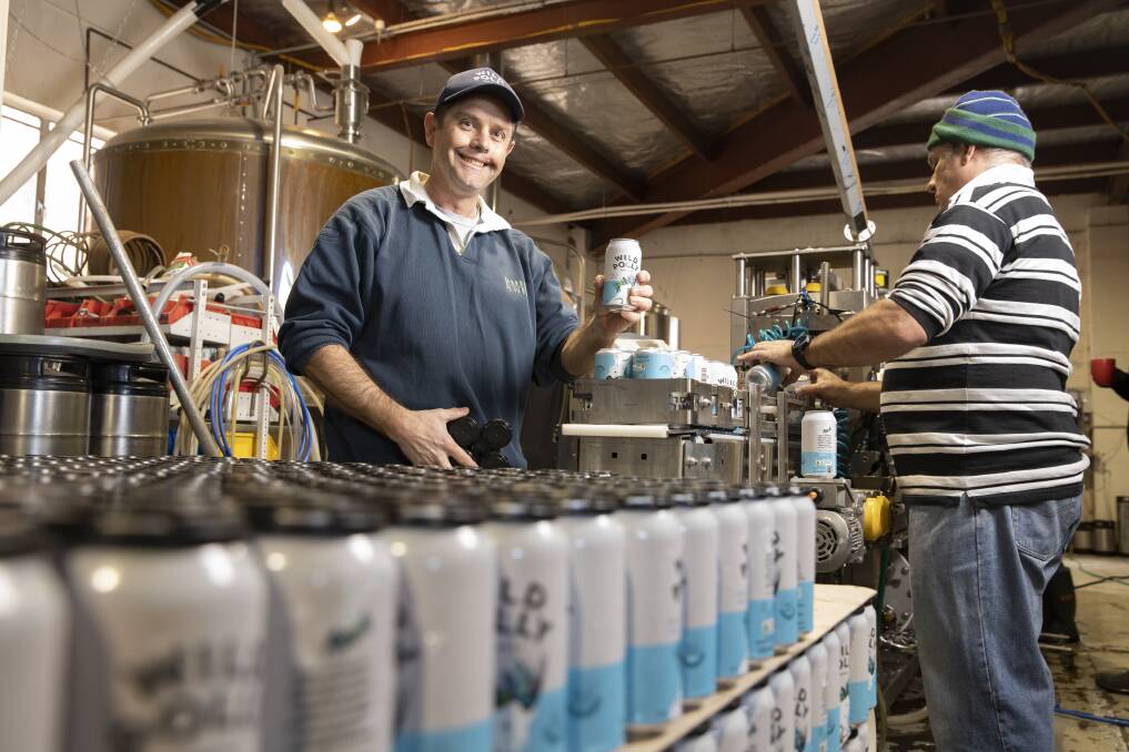 Agricultural scientist Tim Sides, left, canning his gluten-free beer at Wild Polly in Fyshwick. Picture: Sitthixay Ditthavong