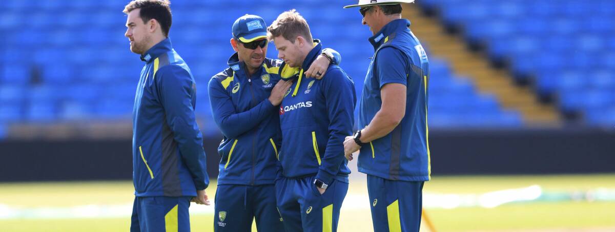 Australia coach Justin Langer, centre left, consoles Steve Smith during training at Headingley on Tuesday. Picture: AP