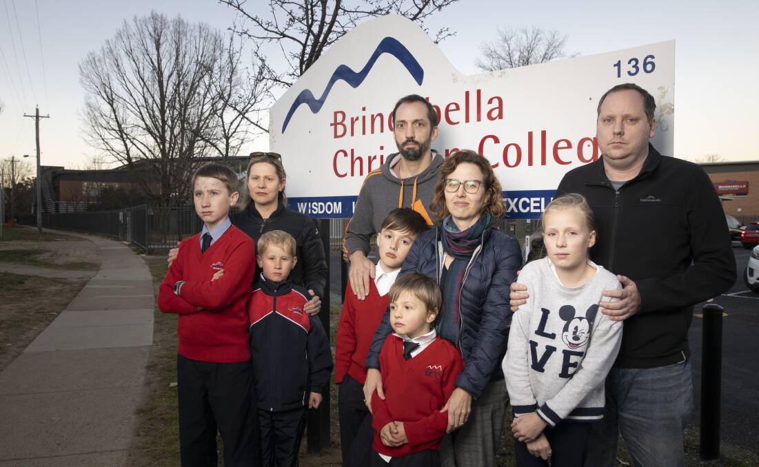 Among the dozens of concerned families at the school are (from left) Bridie Woolnough with sons Toby and Harry, Daniel and April Witteveen with sons Henry and Angus, and Graham Wright with daughter Emma. Picture: Sitthixay Ditthavong