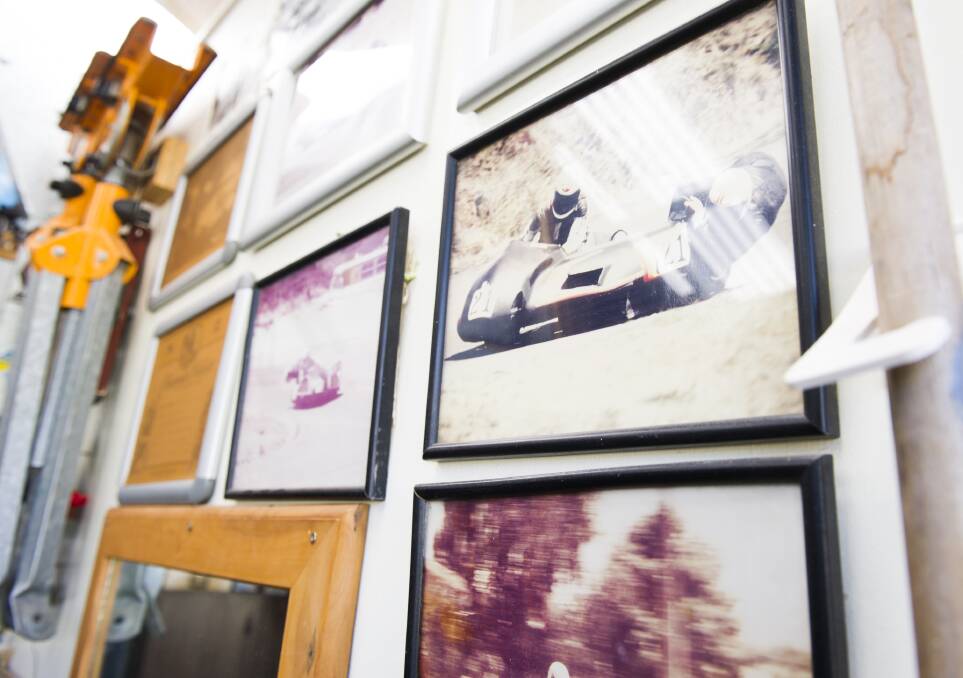 One wall on Alan Francis's man-cave is devoted to photos of his successful career building and racing motorcycle sidecars. Picture: Dion Georgopoulos