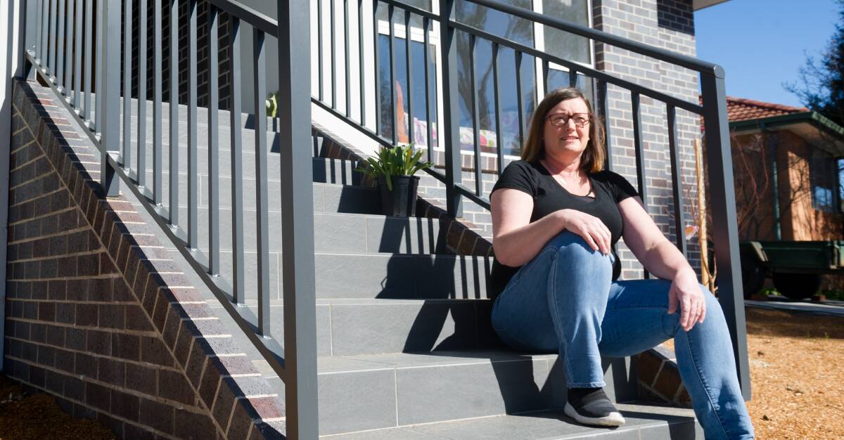Cindy Hansen sits on the steps of her new home in Pearce. Picture: Elesa Kurtz