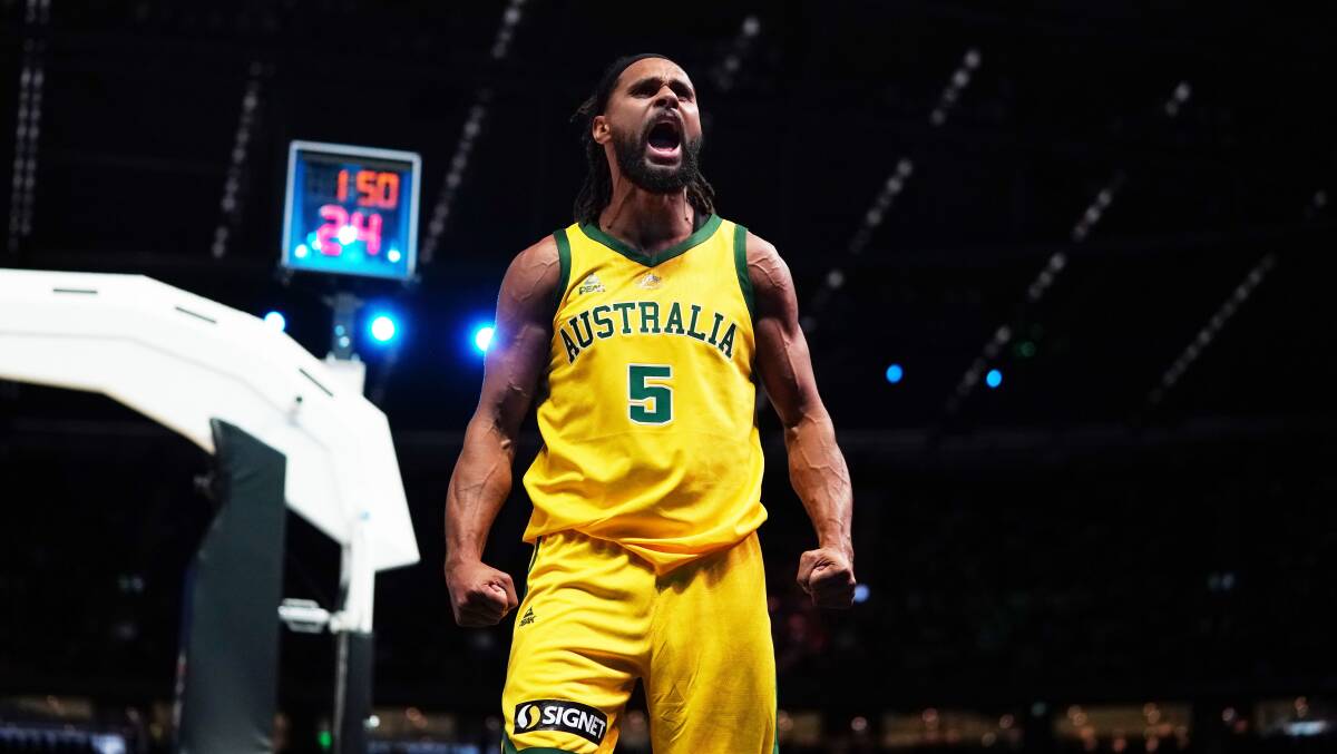 Patty Mills of Australia celebrates after making a basket on Saturday. Picture: AAP
