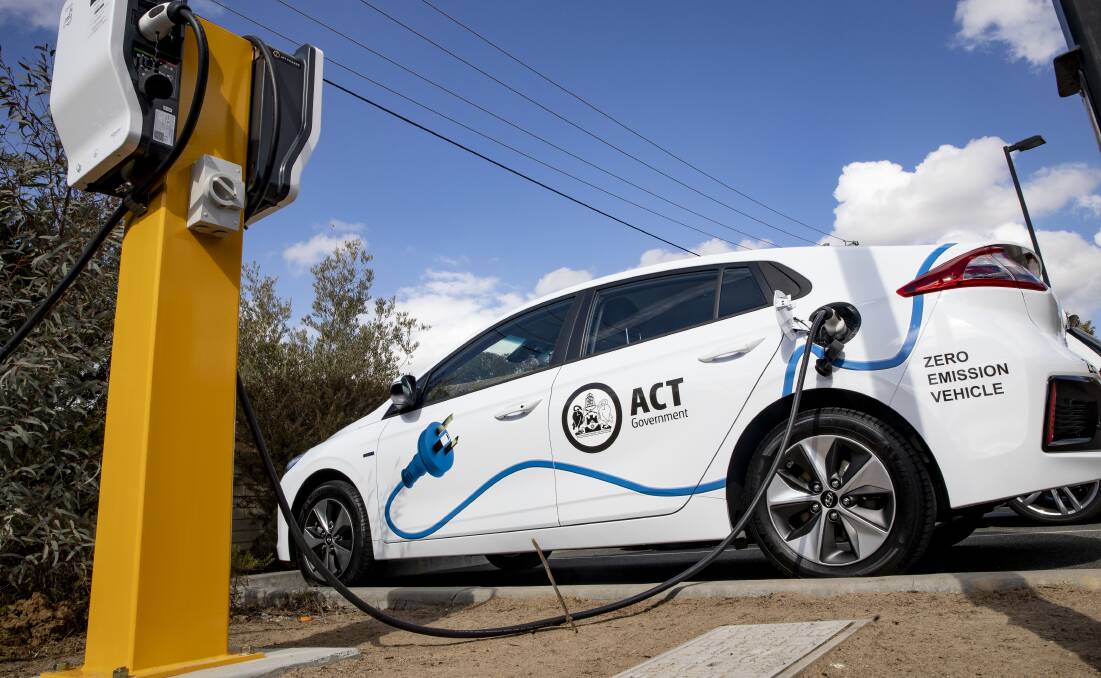 An ACT government vehicle charges at a new electric vehicle charging station in Holt. Picture: Sitthixay Ditthavong