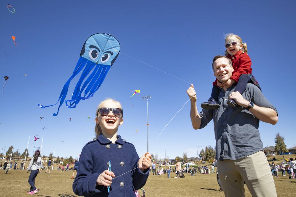 Chloe, 7, Mitch, and Charlotte, 4, Beck at the Googong Kite Fest on Sunday. Picture: Sitthixay Ditthavong