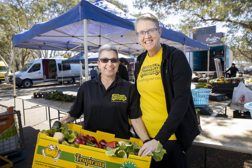 Tracy Smart, right, with her partner Lisa Padzensky, who works for OzHarvest, at the Southside Farmers Market. Picture: Sitthixay Ditthavong