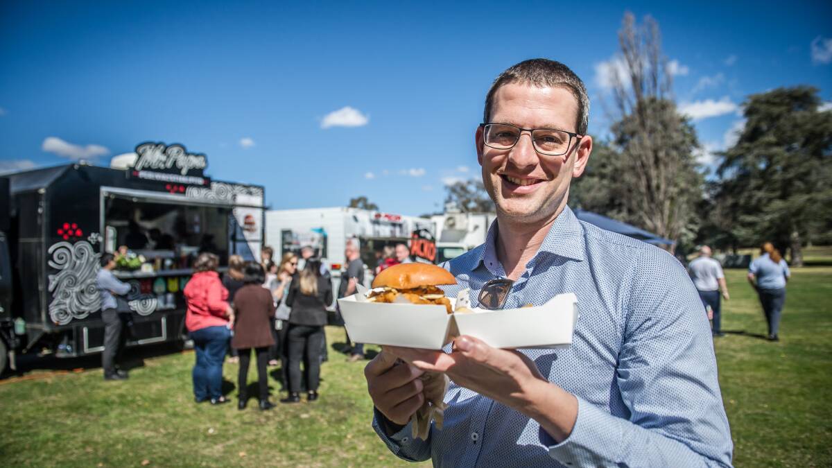 Public servant Alex Blanden purchasing his lunch from the food trucks in the parliamentary triangle. Picture: Karleen Minney
