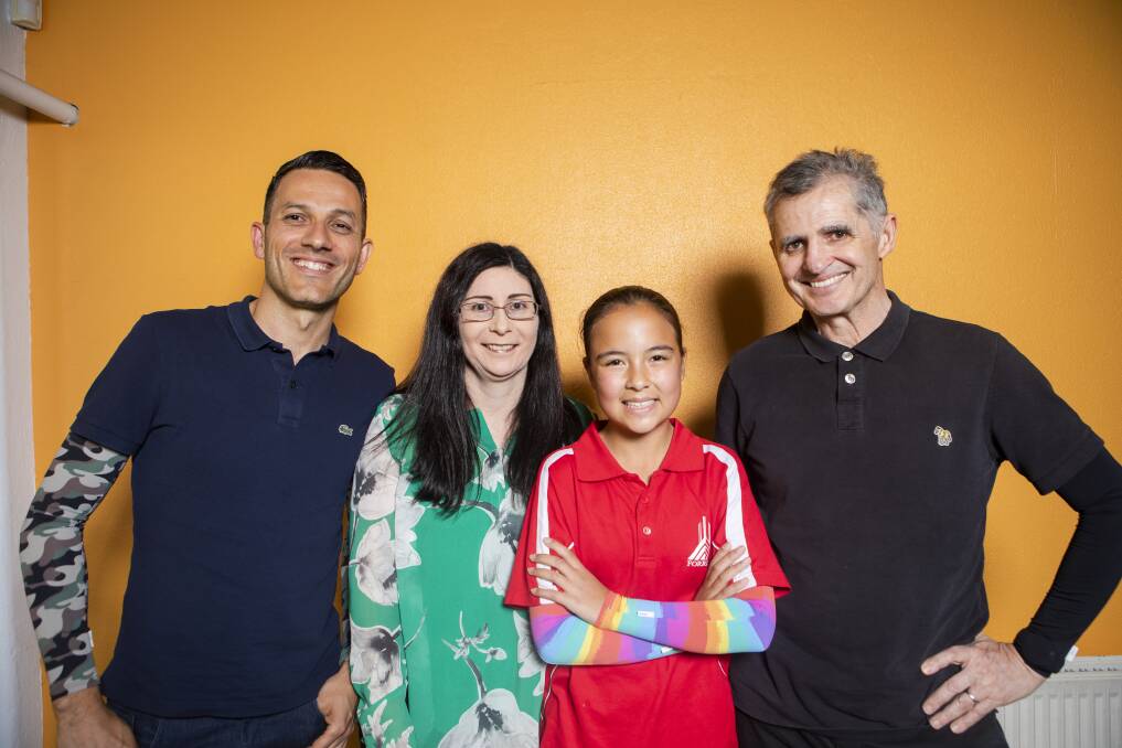 Crazy Arms co-founders Steve Busuttil and Martin Rippon with Cath White and Forrest Primary year 6 student Sienna Dy-Mortimer in her winning design. Picture: Jamila Toderas