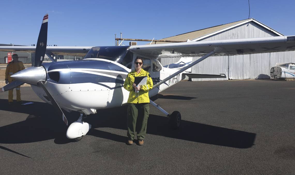 Nadia Rhodes with a NSW Rural Fire Service aircraft, which she could board this bushfire season as she will elect to be on-call for the service. Picture: Supplied