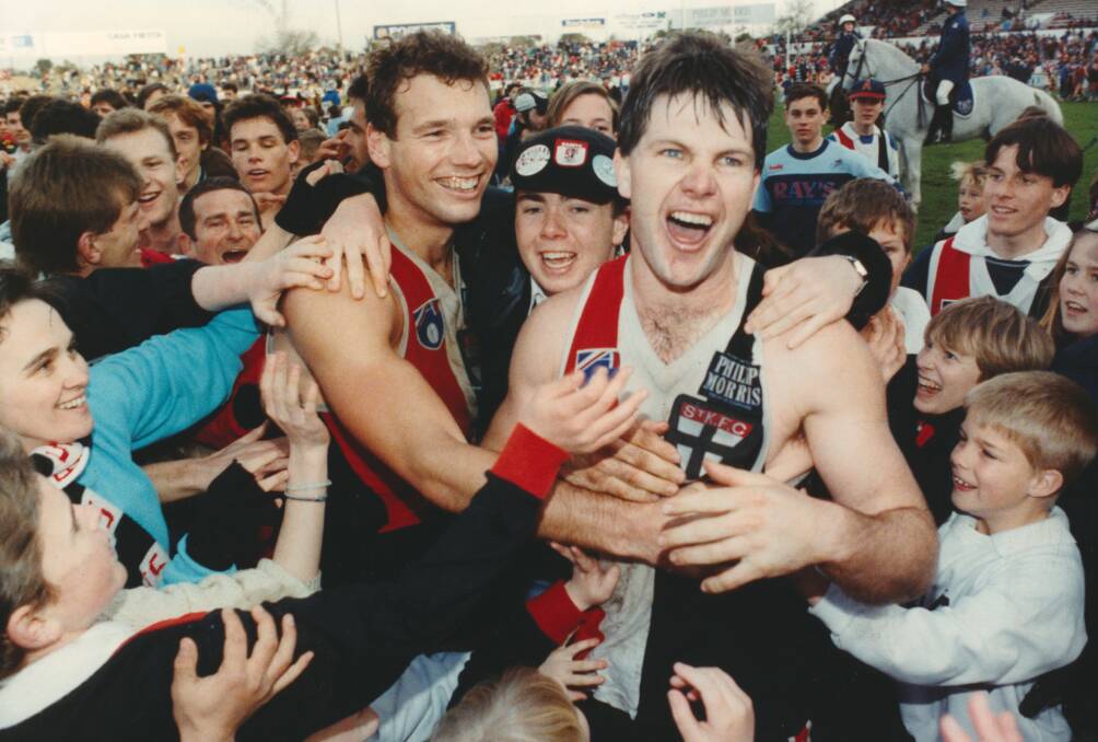 St Kilda footballers Stewart Loewe and Danny Frawley celebrate after beating Fitzroy by one point in August 1990. 