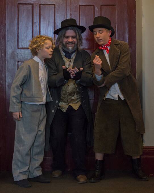 From left, Oliver (Willum Hollier-Smith), Fagin (Anthony Swadling) and Artful Dodger (Joss Kent) in Queanbeyan Players' Oliver! Picture: Michael Moore
