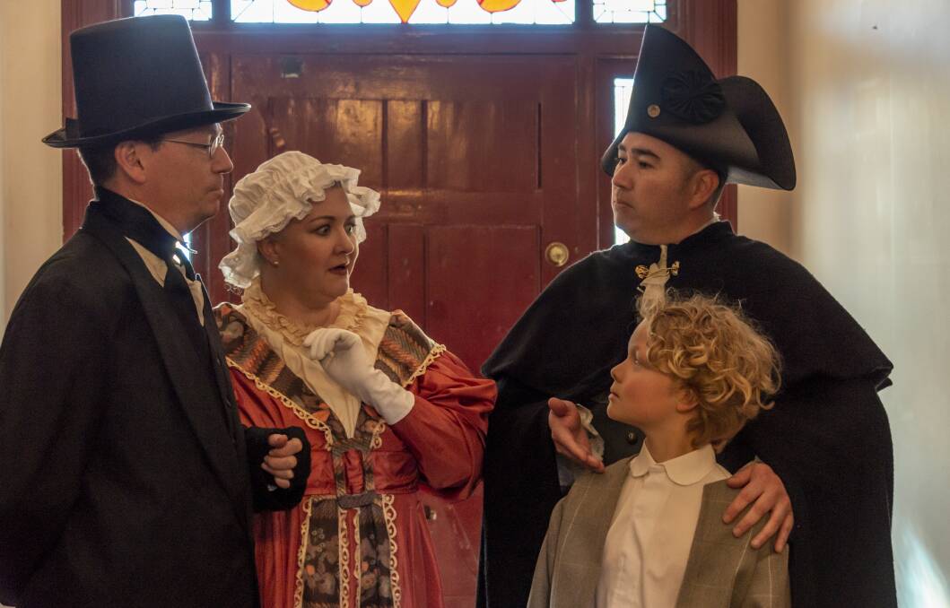From left, Mr and Mrs Sowberry (John Potter and Sarah Powell), Mr Bumble (Chris Bennie) and Oliver (Willum Hollier-Smith) in Queanbeyan Players' Oliver! Picture: Michael Moore