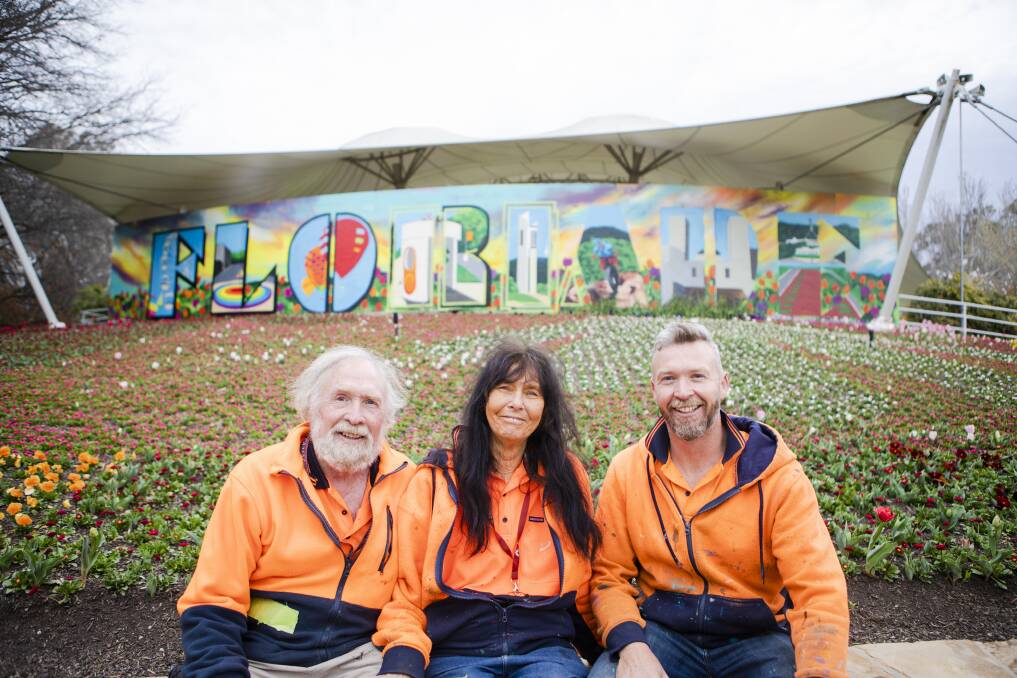 Graffikpaint artists Peter, Jenny and Geoff Filmer in front of their Floriade mural. Picture: Jamila Toderas